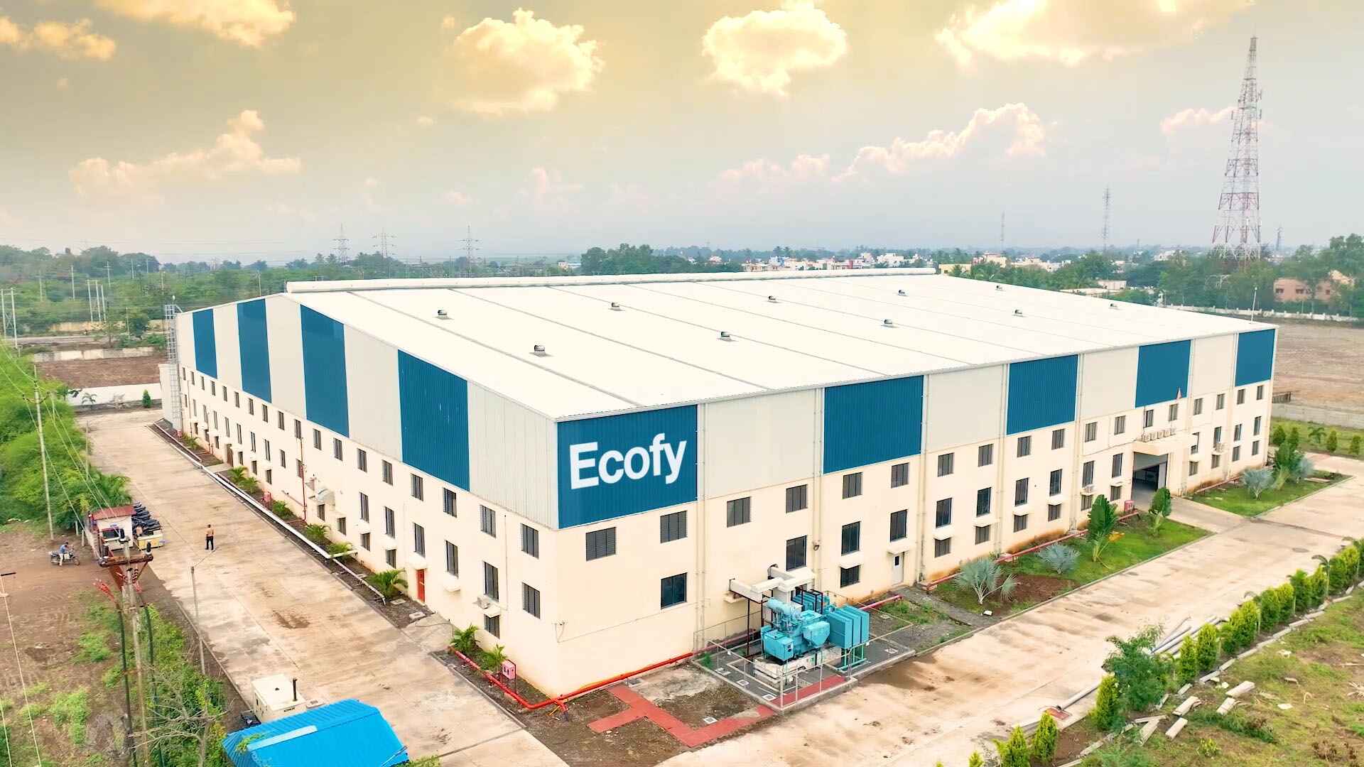 Aerial view of Ecofy's 150,000 sq ft manufacturing facility in Chhatrapati Sambhajinagar (Aurangabad) MIDC, Maharashtra: the Ecofy branded building under sunset sky